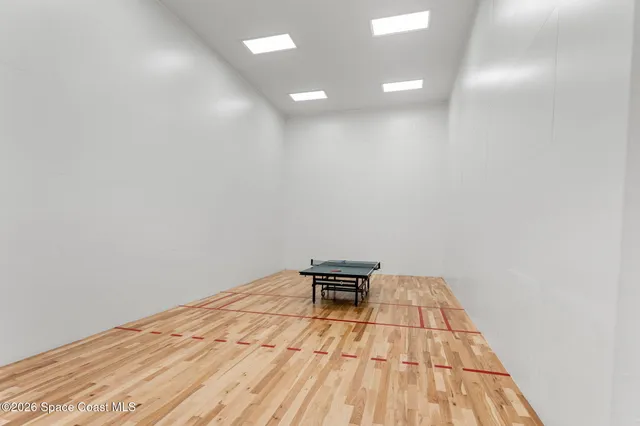 a aerial view of a house with swimming pool and large trees