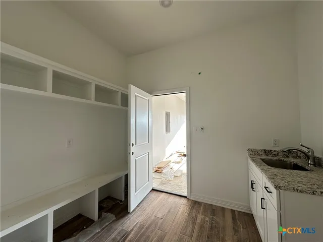 a view of a storage and utility room in wooden floor
