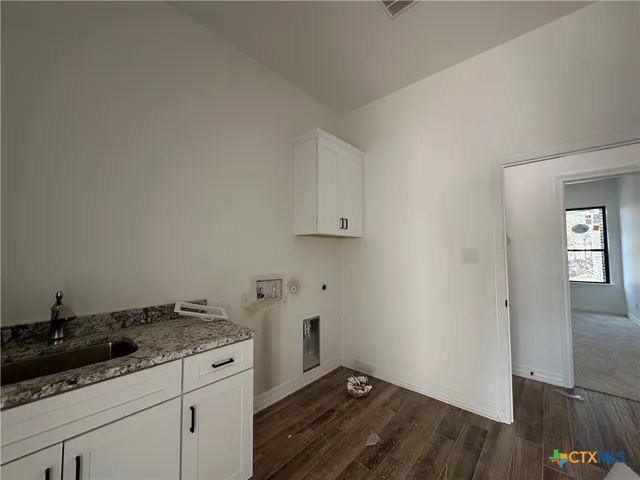 a bathroom with a granite countertop sink a toilet and shower