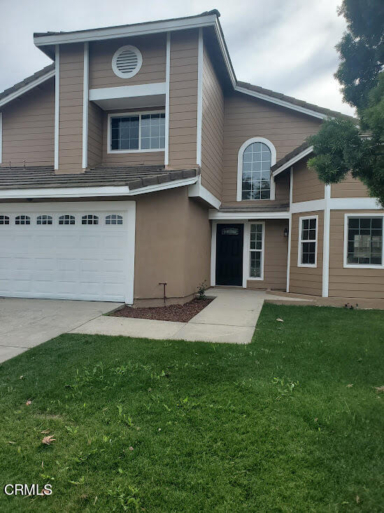 410 Bluebell Place Oxnard, CA 93036 - Photo 1 of 20 a front view of a house with a yard and garage