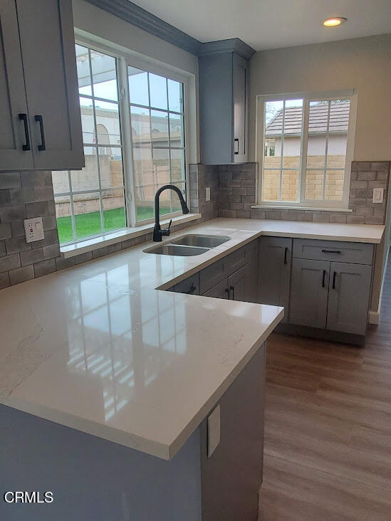 410 Bluebell Place Oxnard, CA 93036 - Photo 4 of 20 a kitchen with a sink a window and cabinets