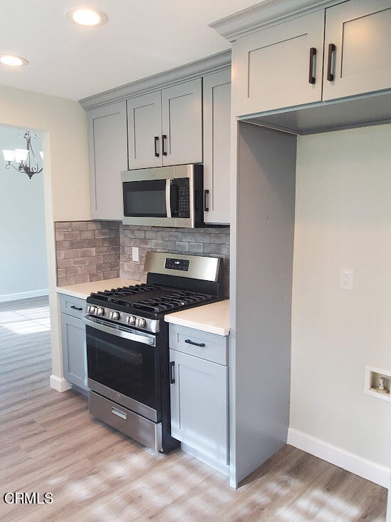 410 Bluebell Place Oxnard, CA 93036 - Photo 5 of 20 a kitchen with stainless steel appliances granite countertop a stove and a microwave