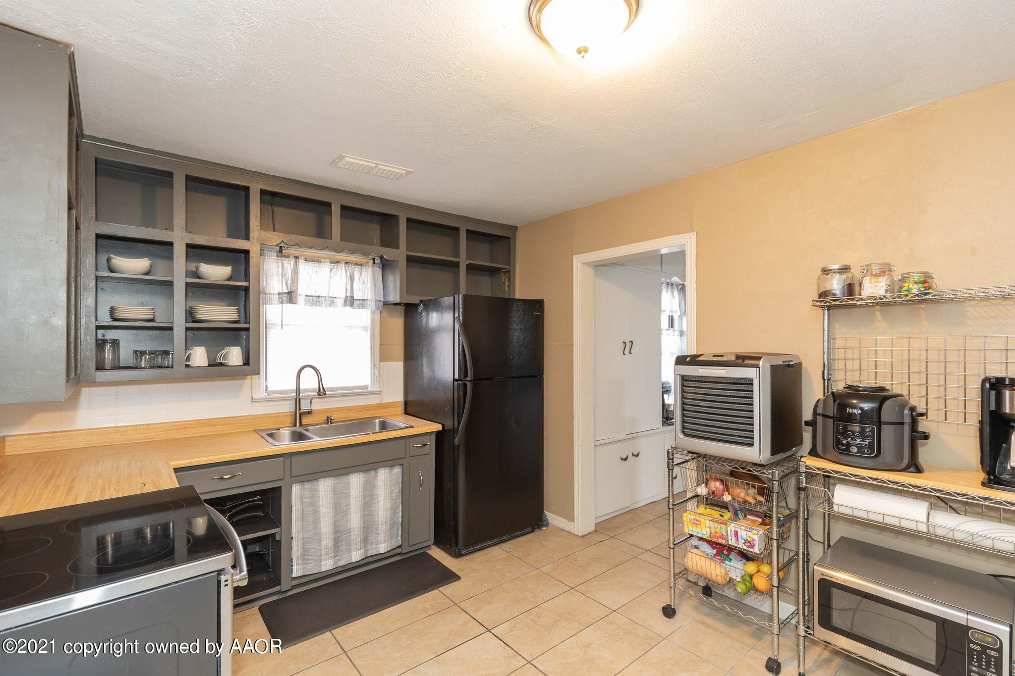 3609 South Taylor Street Amarillo, TX 79110 - Photo 8 of 26 a kitchen that has a sink and a refrigerator