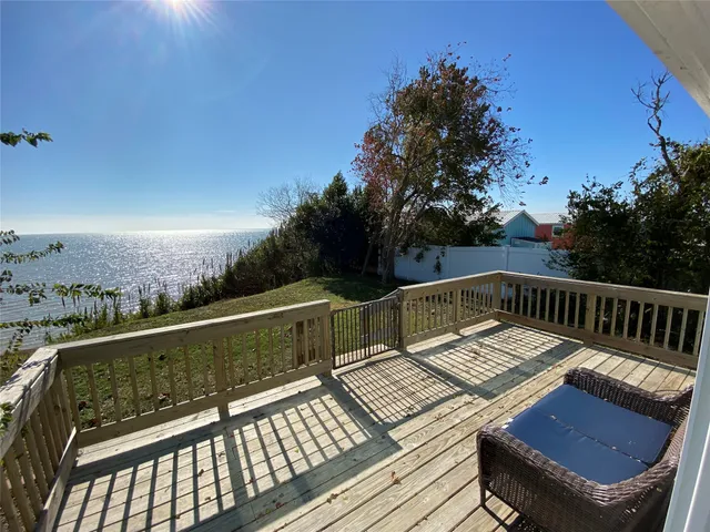 a view of balcony with wooden floor and outdoor seating