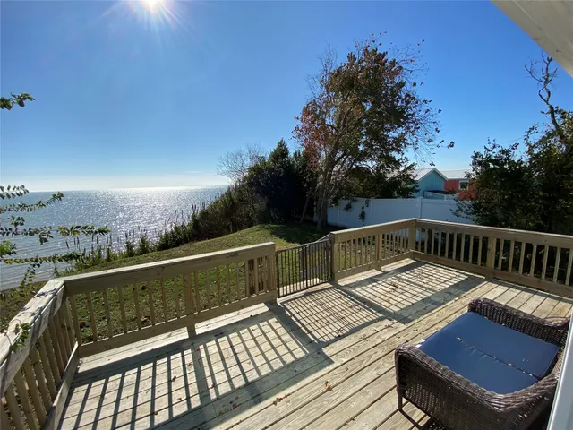 a view of balcony with wooden floor and outdoor seating