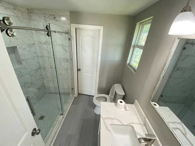 a bathroom with a sink and shower