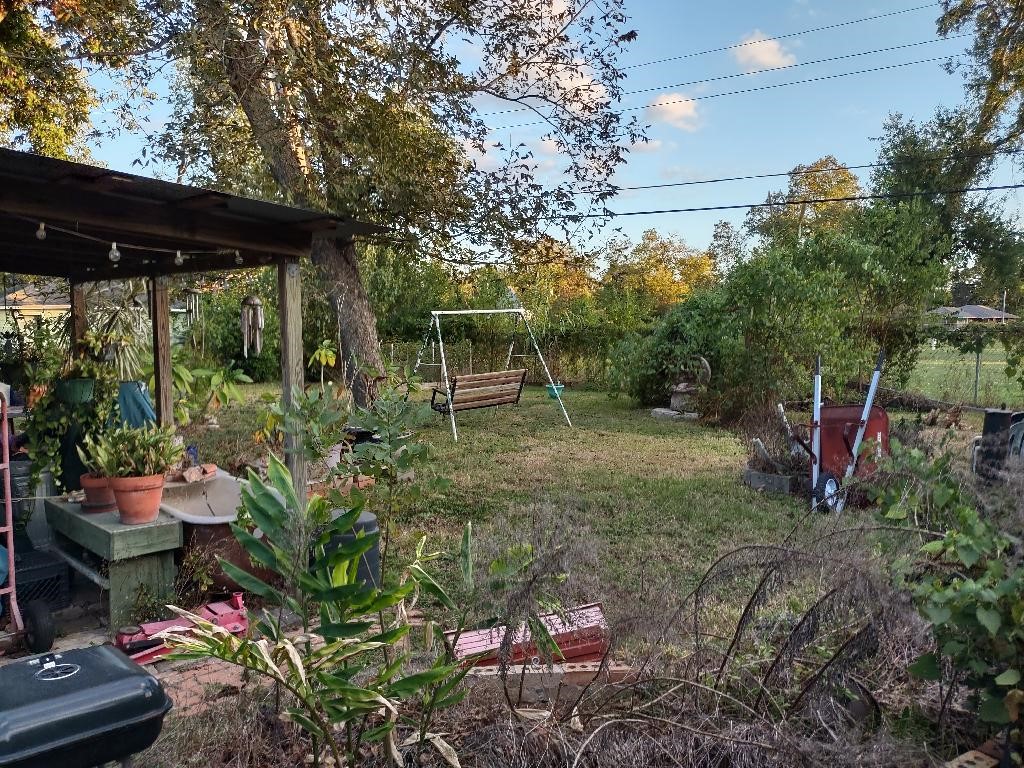 4725 Carleen Road Houston, TX 77092 - Photo 12 of 14 a backyard of a house with lots of green space and fountain