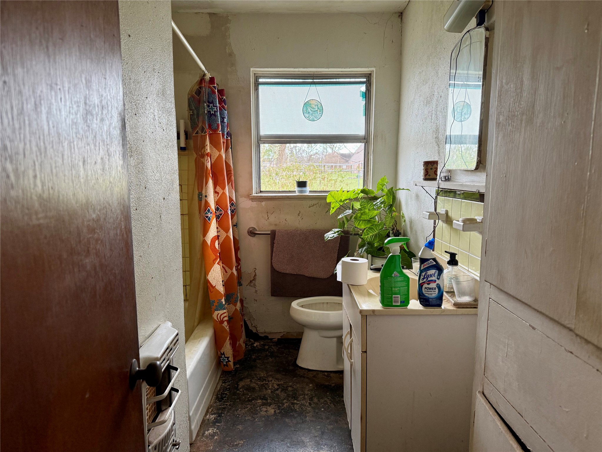 4725 Carleen Road Houston, TX 77092 - Photo 10 of 14 a bathroom with a toilet a sink and a mirror