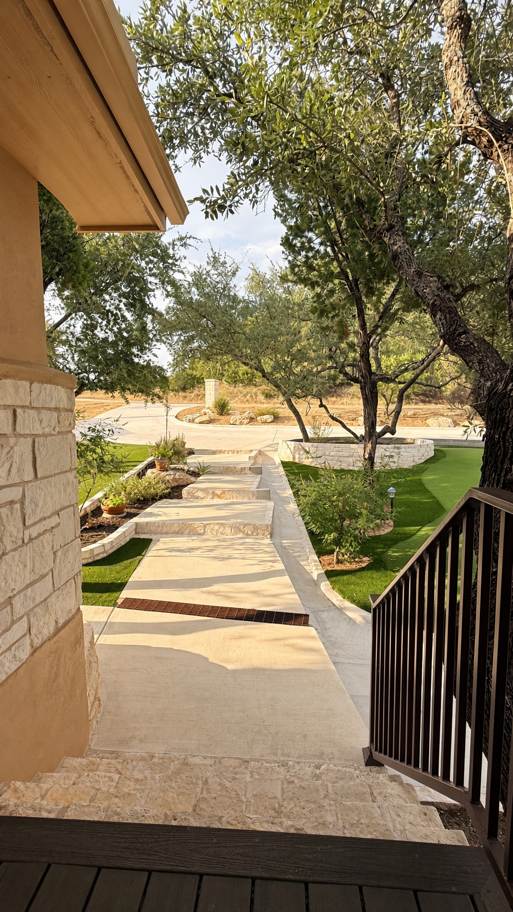 19005 White Rim Trail Jonestown, TX 78645 - Photo 1 of 39 A stone walkway winds through manicured grounds bordered by mature trees.