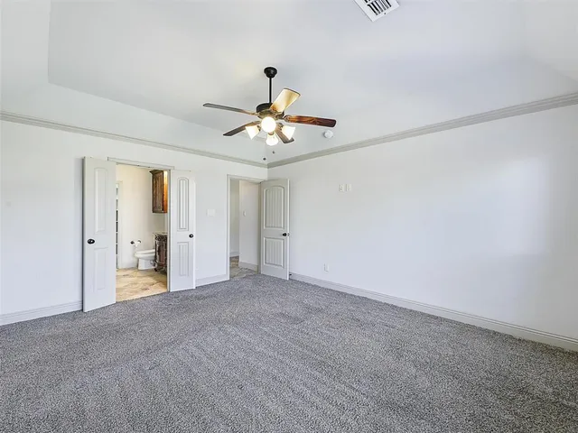 a view of an empty room with a ceiling fan