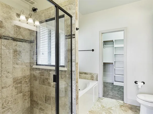 a bathroom with a bathtub and a shower