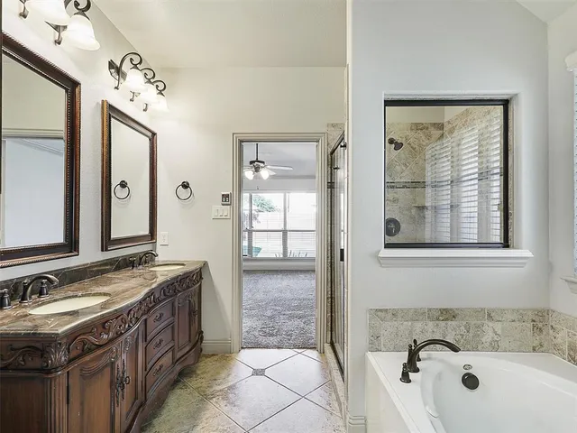 a bath room with a sink and a bath tub