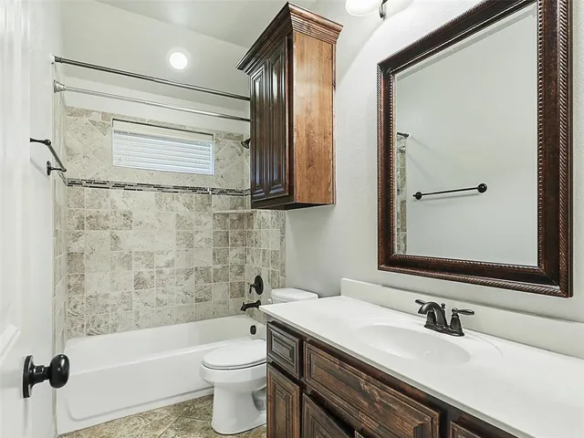 a bathroom with a sink a toilet and a bathtub