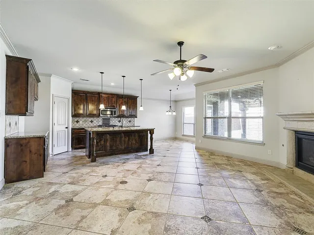 a large white kitchen with a large window and kitchen