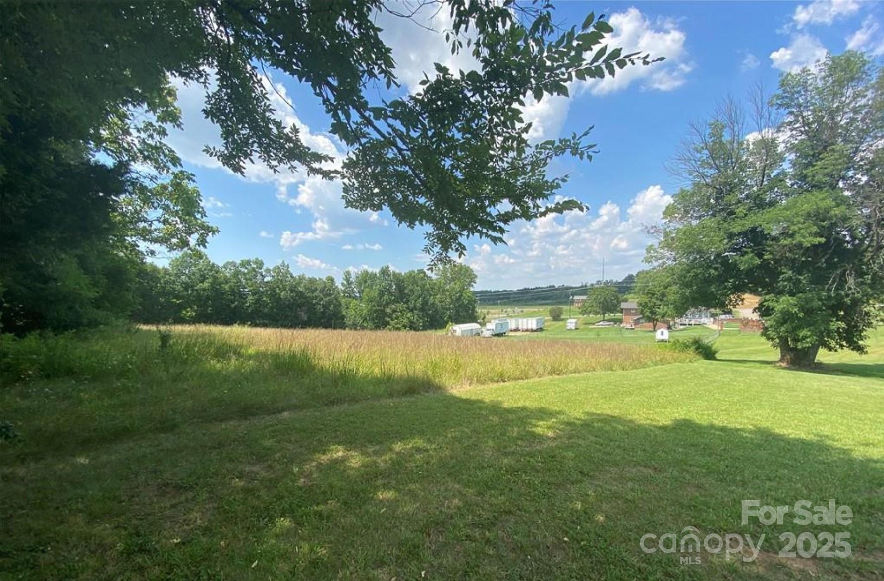 7501 Ruben Linker Road Northwest Concord, NC 28027 - Photo 3 of 6 a view of a lake from a yard