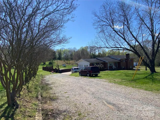 a view of a house with truck parked in a yard