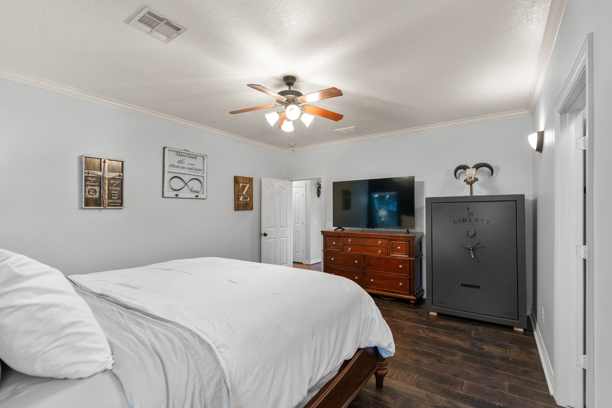 5942 Wildflower Road Sealy, TX 77474 - Photo 13 of 41 a bedroom with a bed and a flat screen tv