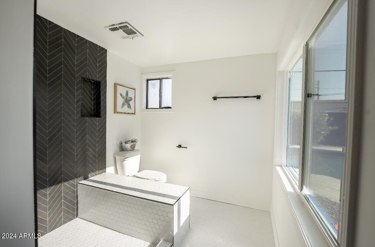 1731 East Verde Lane Phoenix, AZ 85016 - Photo 13 of 26 a bathroom with a toilet sink and shower