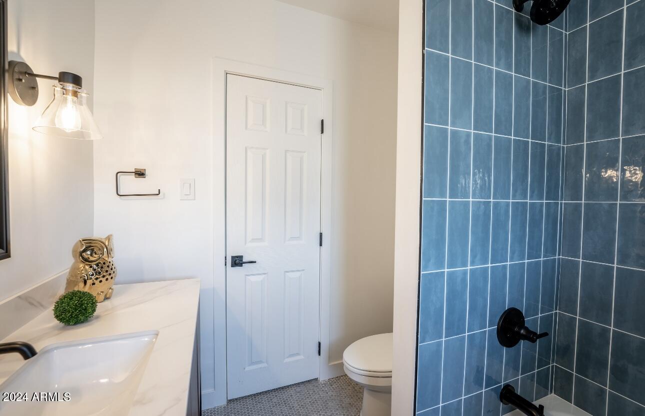 1731 East Verde Lane Phoenix, AZ 85016 - Photo 17 of 26 a bathroom with a toilet and a shower