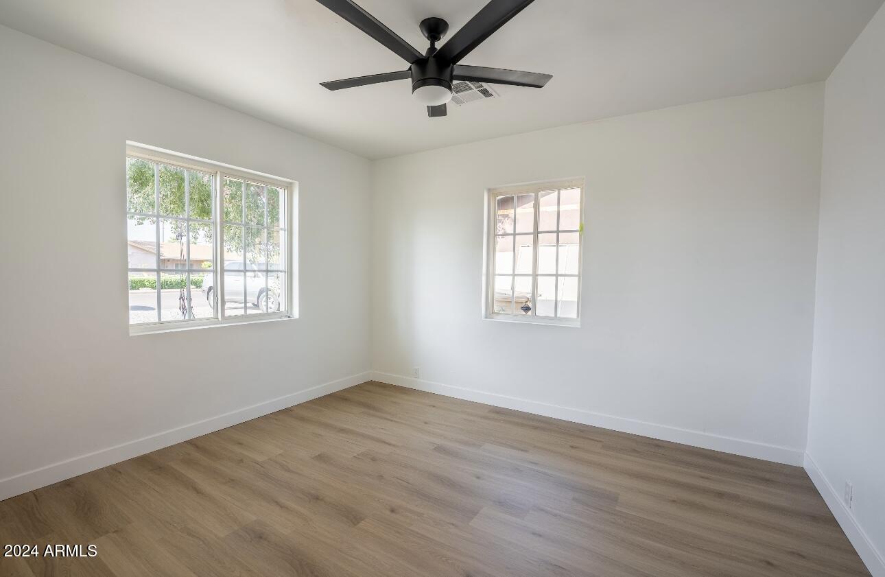 1731 East Verde Lane Phoenix, AZ 85016 - Photo 18 of 26 a view of a livingroom with a window and wooden floor