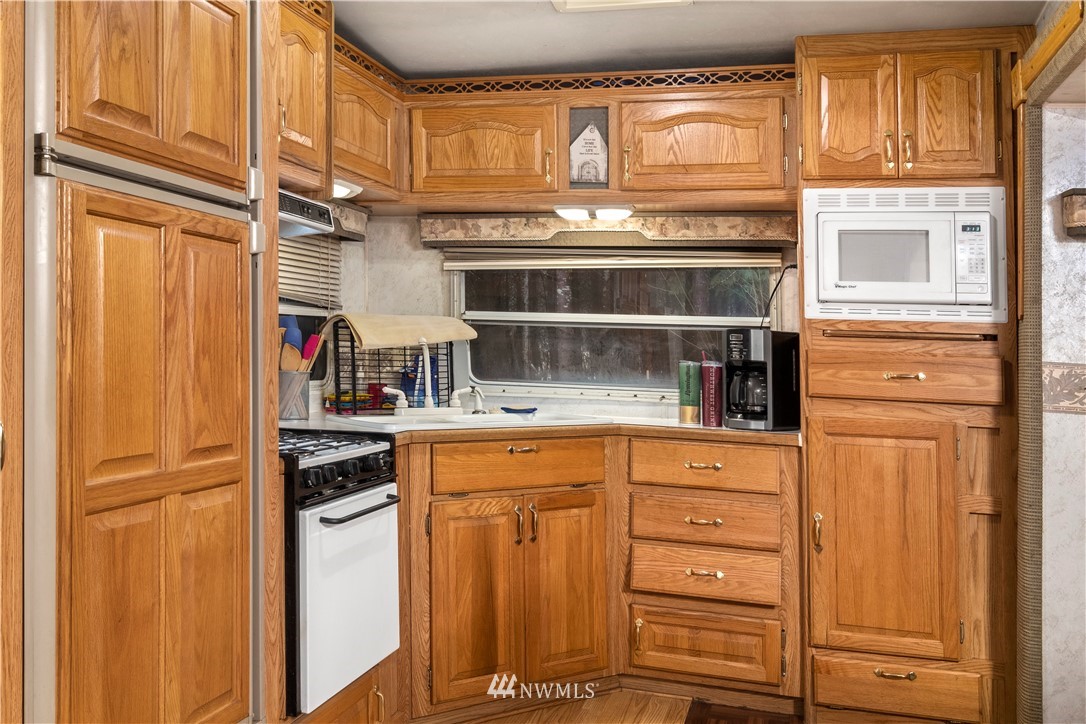 220 Labarre Road Chehalis, WA 98532 - Photo 5 of 34 a kitchen with stainless steel appliances a refrigerator and cabinets