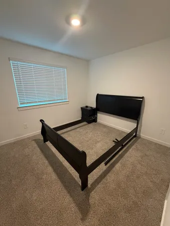 a bedroom with a bed and window