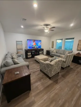 a living room with furniture and a flat screen tv
