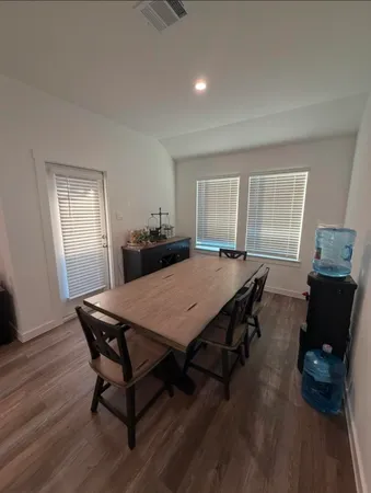 a dining room with a table and chairs