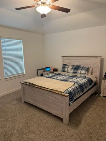 a bed sitting in a bedroom next to a window