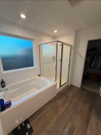 a bathroom with a bathtub and a shower