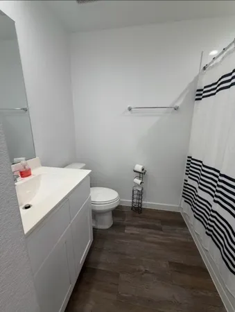 a white toilet sitting next to a bathroom sink