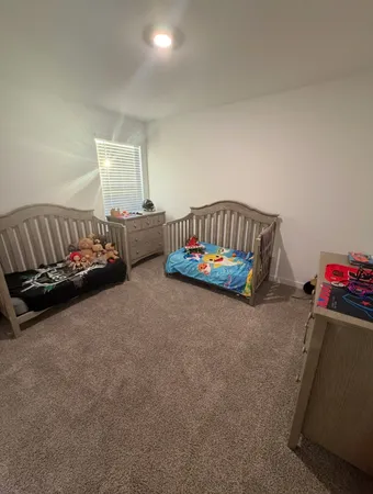 a bedroom with furniture and a window