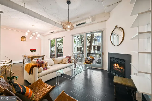 a living room with furniture a fireplace and a chandelier