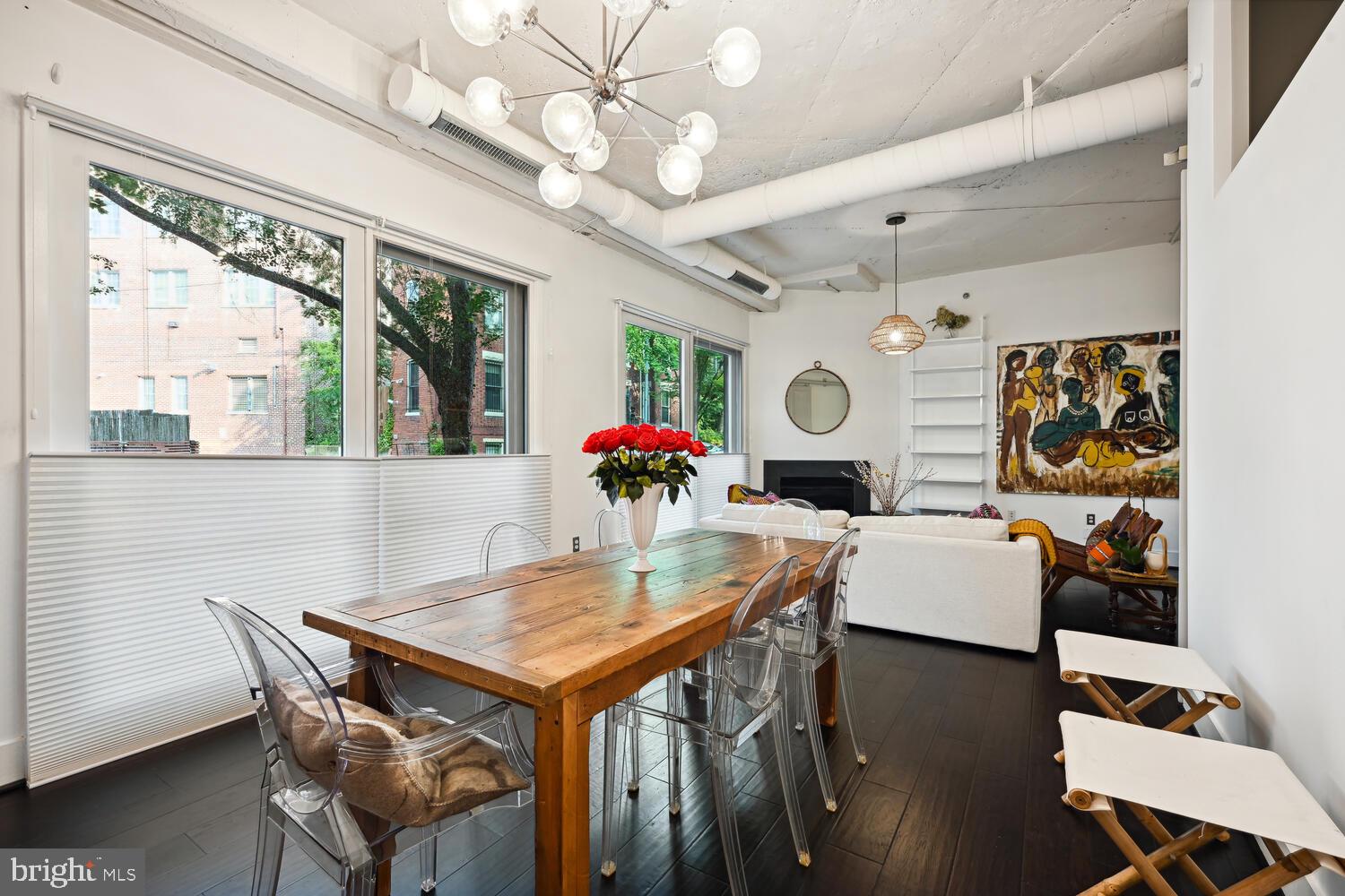 1700 Kalorama Road Northwest, Unit 207 Washington, DC 20009 - Photo 11 of 27 a view of a dining room with furniture a chandelier and wooden floor