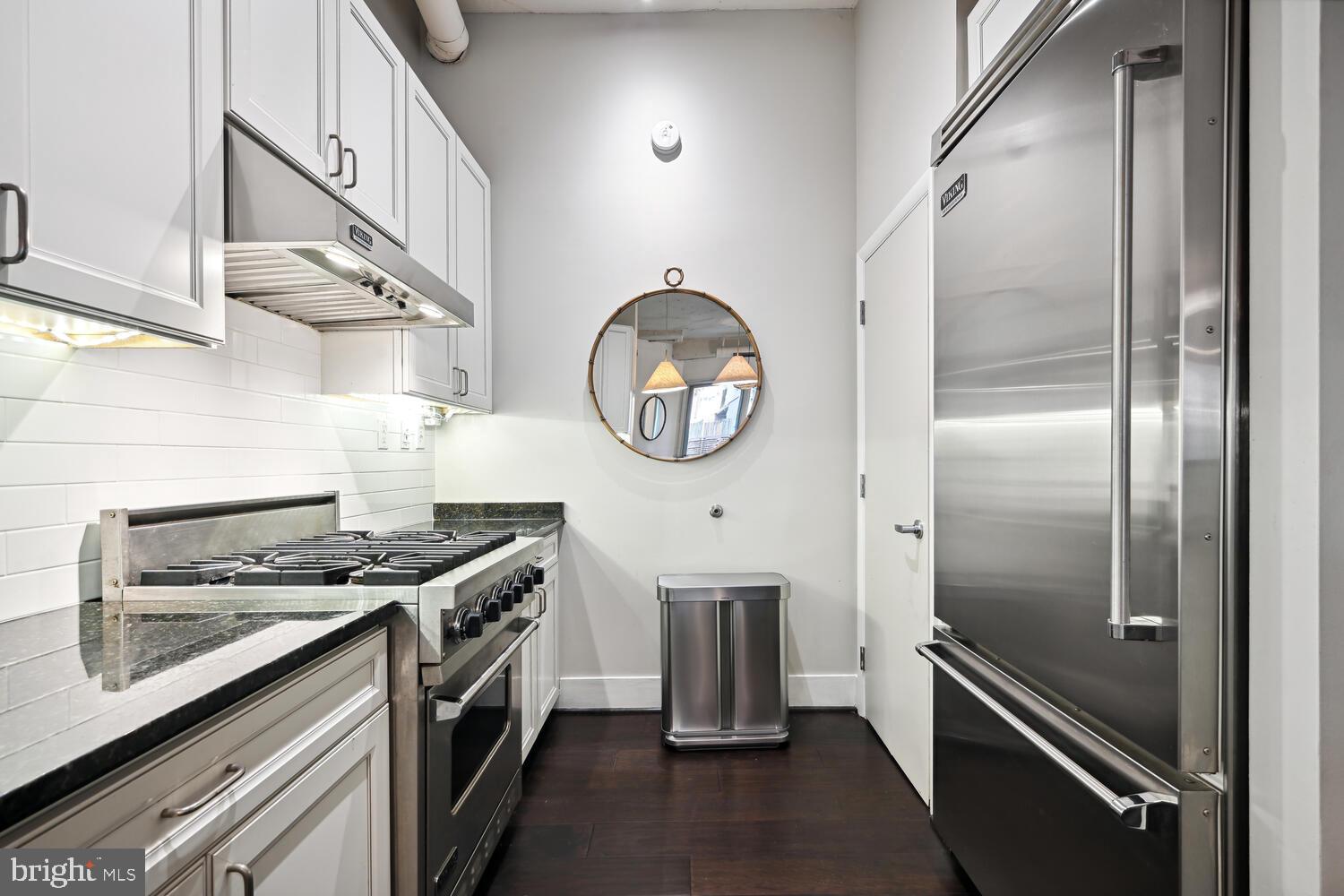 1700 Kalorama Road Northwest, Unit 207 Washington, DC 20009 - Photo 9 of 27 a kitchen with stainless steel appliances granite countertop a stove and a refrigerator