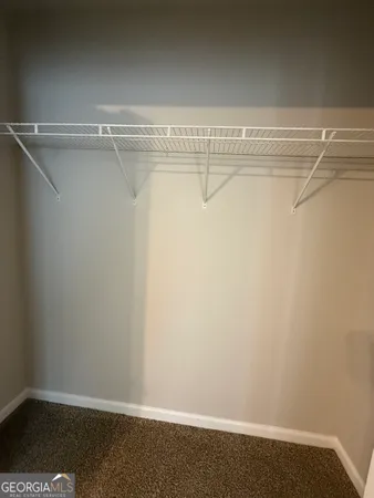 an empty room with a ceiling fan and a window