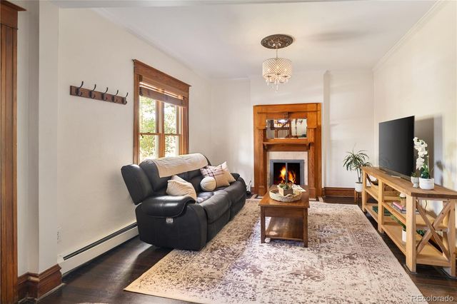 a living room with furniture a window and a flat screen tv