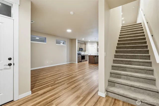 a view of a room with wooden floor and stairs