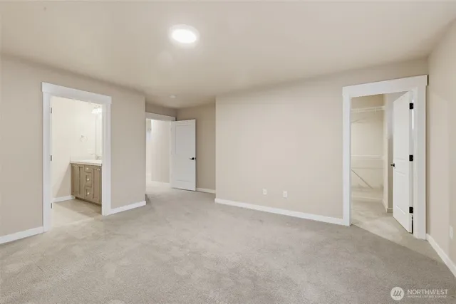 a bathroom with double vanity sinks and a mirror