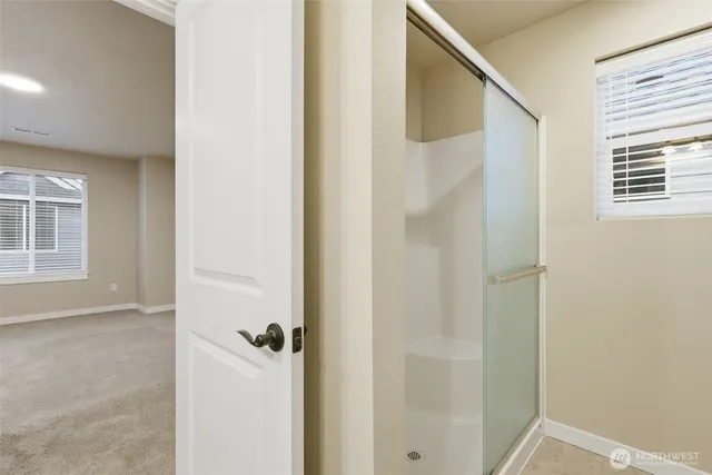 a white toilet sitting next to a shower