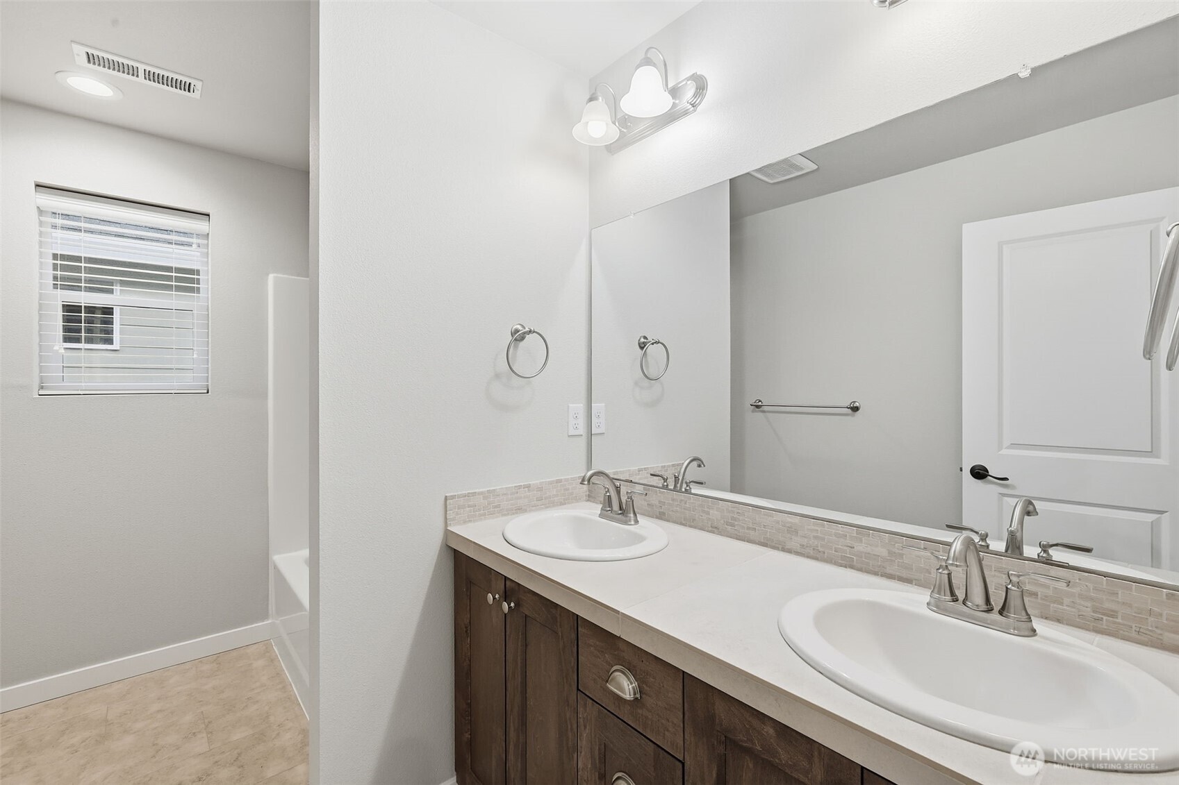 7110 South 13th Street Ridgefield, WA 98642 - Photo 24 of 28 a bathroom with a sink double vanity and a mirror