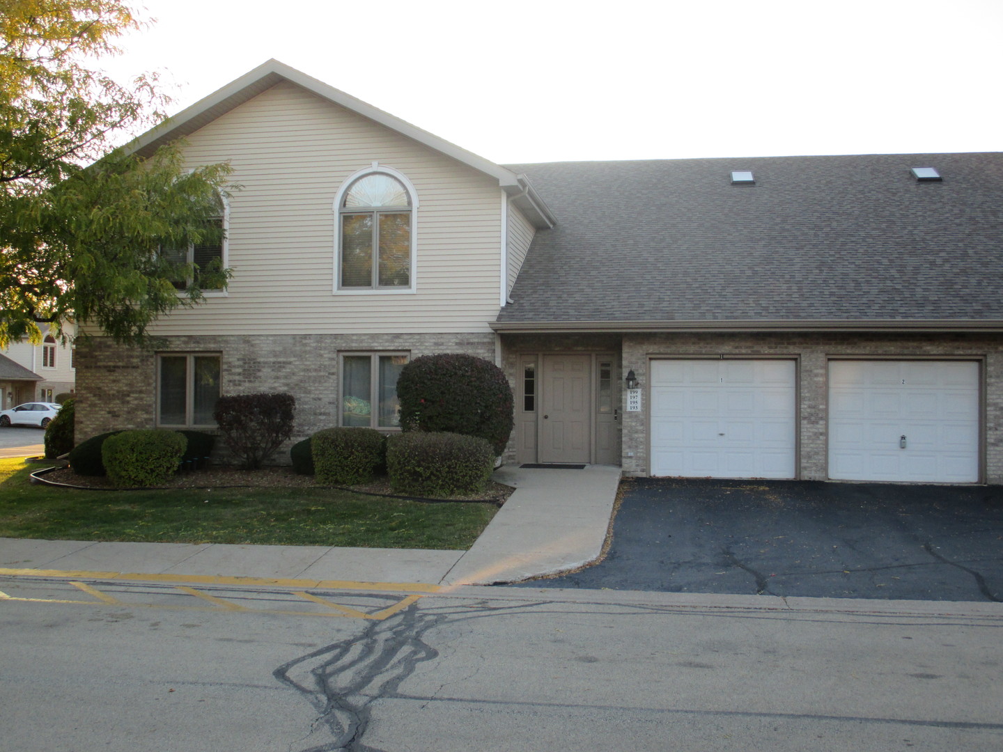193 Saenz Lane, Unit 193 Joliet, IL 60436 - Photo 1 of 14 a front view of a house with a yard