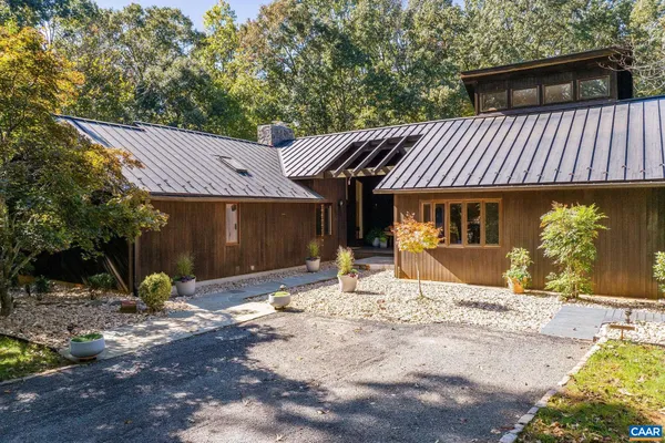 a view of a house with a patio and a yard