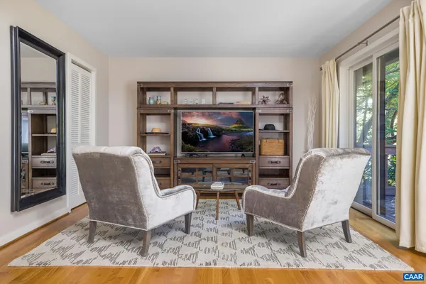 a bedroom with a bed and a tv on the dresser