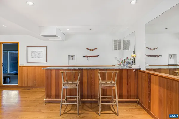 a bedroom with a bed chair and painting on the wall