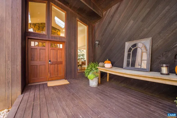 a living room with fireplace furniture and a large window