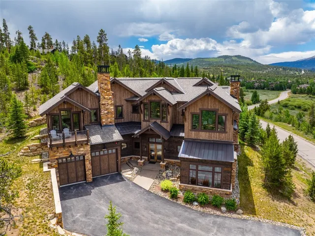 an aerial view of a house with yard and pool table and chairs