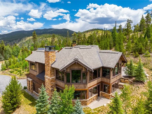 an aerial view of a house with a yard and balcony