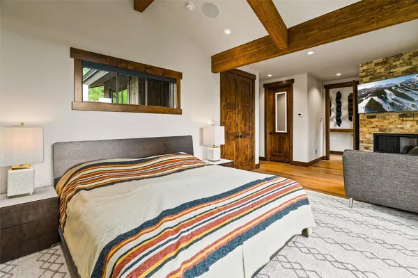 a bedroom with bed and wooden floor