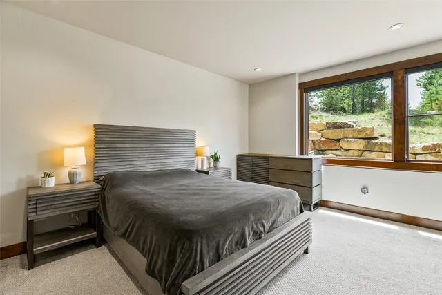 a bedroom with a bed and windows